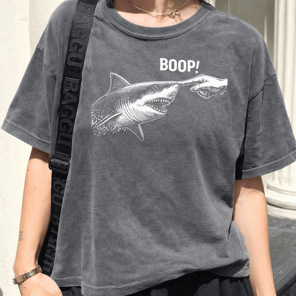 Full Sail Marine Boop shark graphic women's boxy tee in gray – model wearing oversized Comfort Colors tee with great white shark booping finger design – lifestyle view