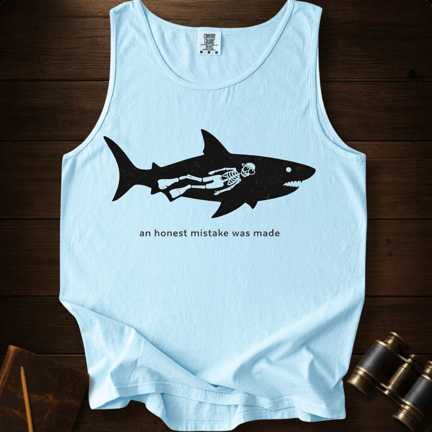 Full Sail Marine An Honest Mistake shark skeleton graphic Comfort Colors tank top in Chambray – funny ocean art quote design – front view