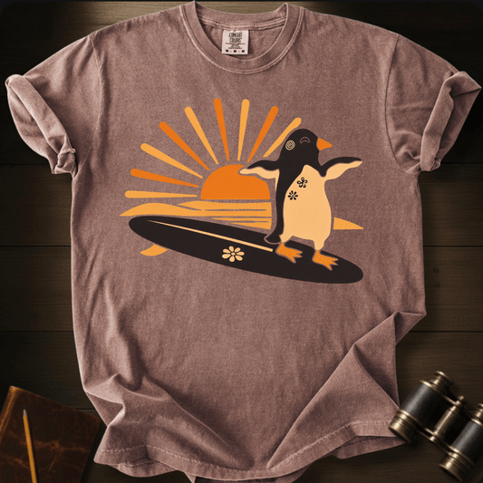 Full Sail Marine Sunset Surf penguin surfing graphic Comfort Colors t-shirt in espresso – cute penguin on surfboard with sunset design – front view