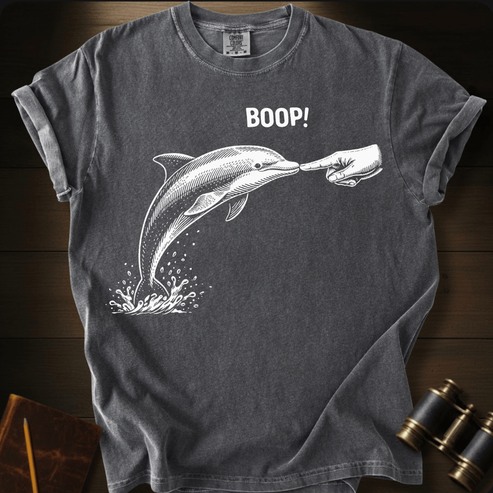 Full Sail Marine Boop! dolphin graphic Comfort Colors t-shirt in pepper – white dolphin being booped on nose with hand and BOOP text design – front view