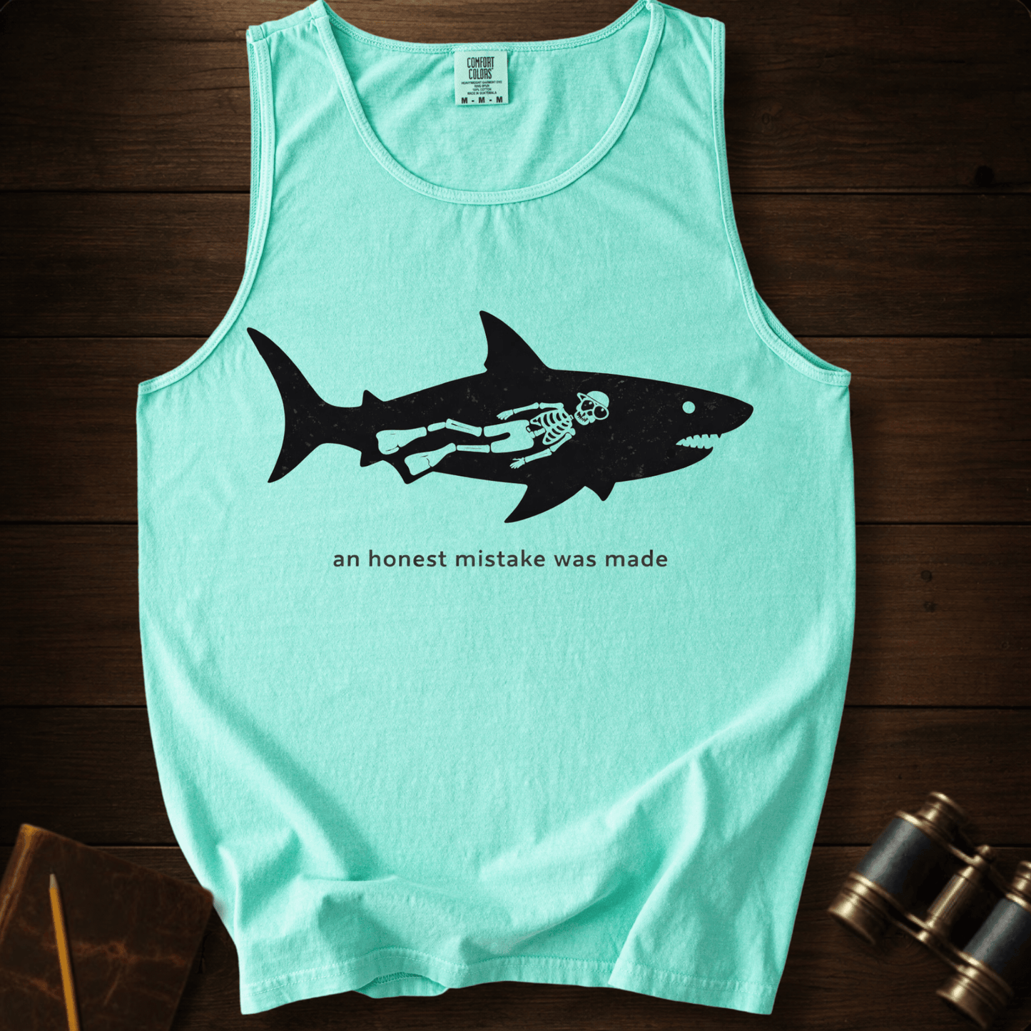 Full Sail Marine An Honest Mistake shark skeleton graphic Comfort Colors tank top in Island Reef – funny ocean art quote design – front view