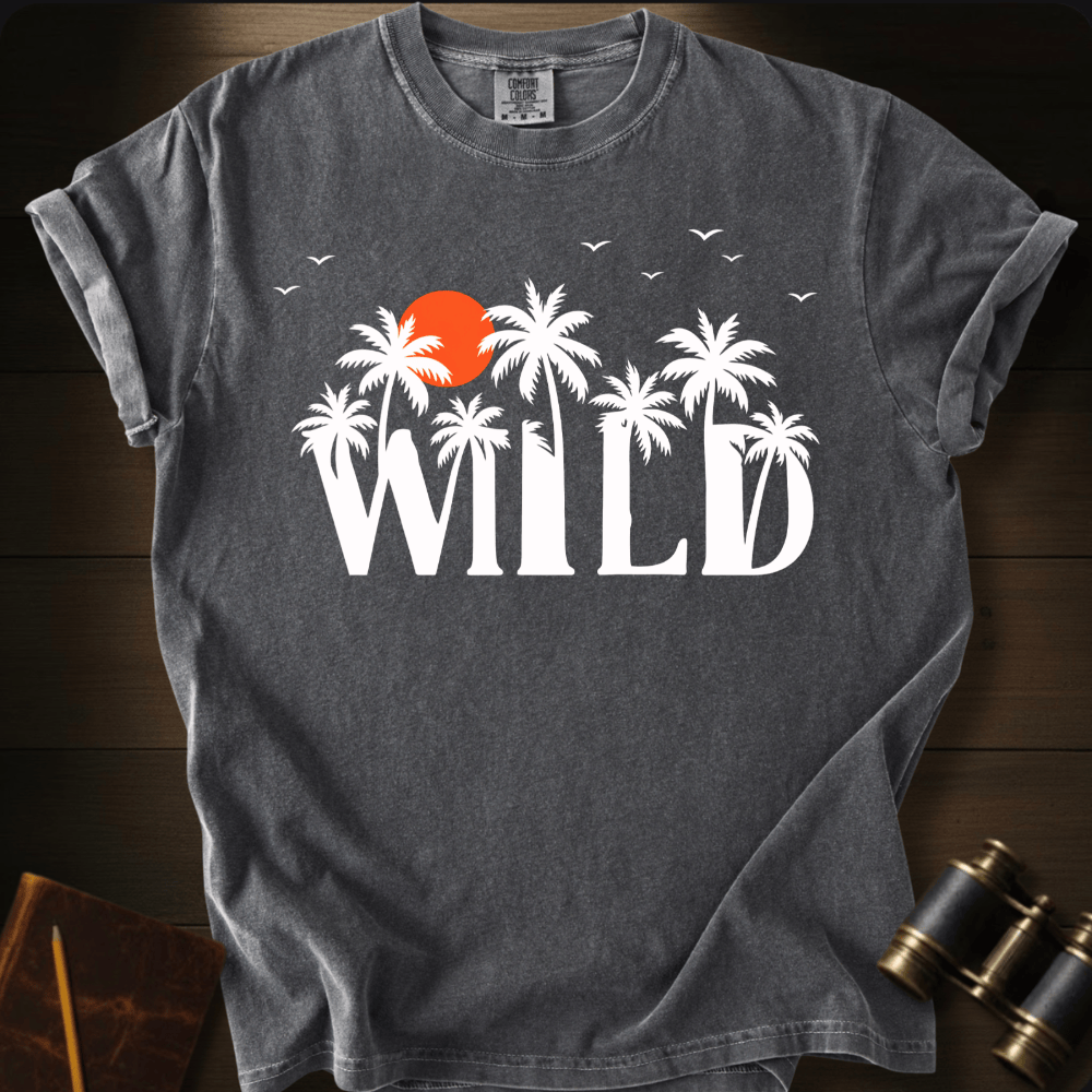 Full Sail Marine Wild palm trees and sunset graphic Comfort Colors t-shirt in pepper – white tropical WILD text with orange sun and birds design – front view