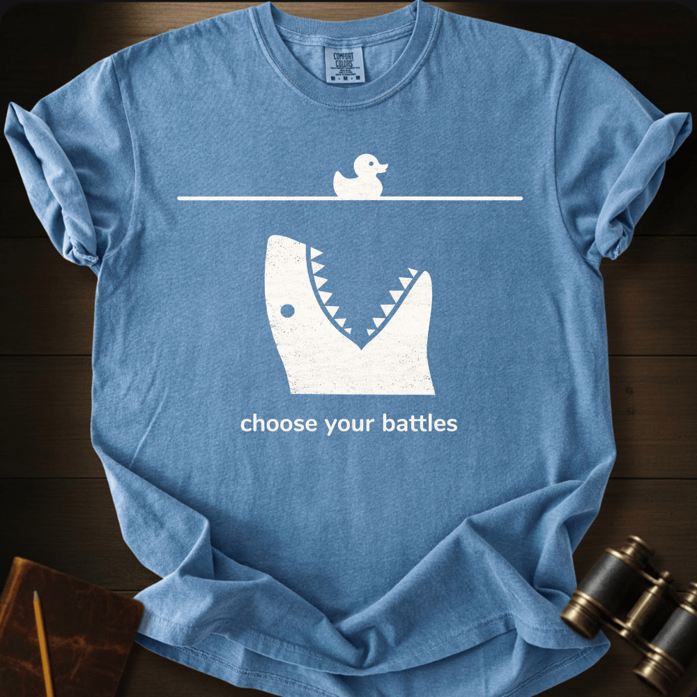 Full Sail Marine Choose Your Battles rubber duck and shark jaw funny graphic Comfort Colors t-shirt in blue jean – humorous ocean predator design – front view