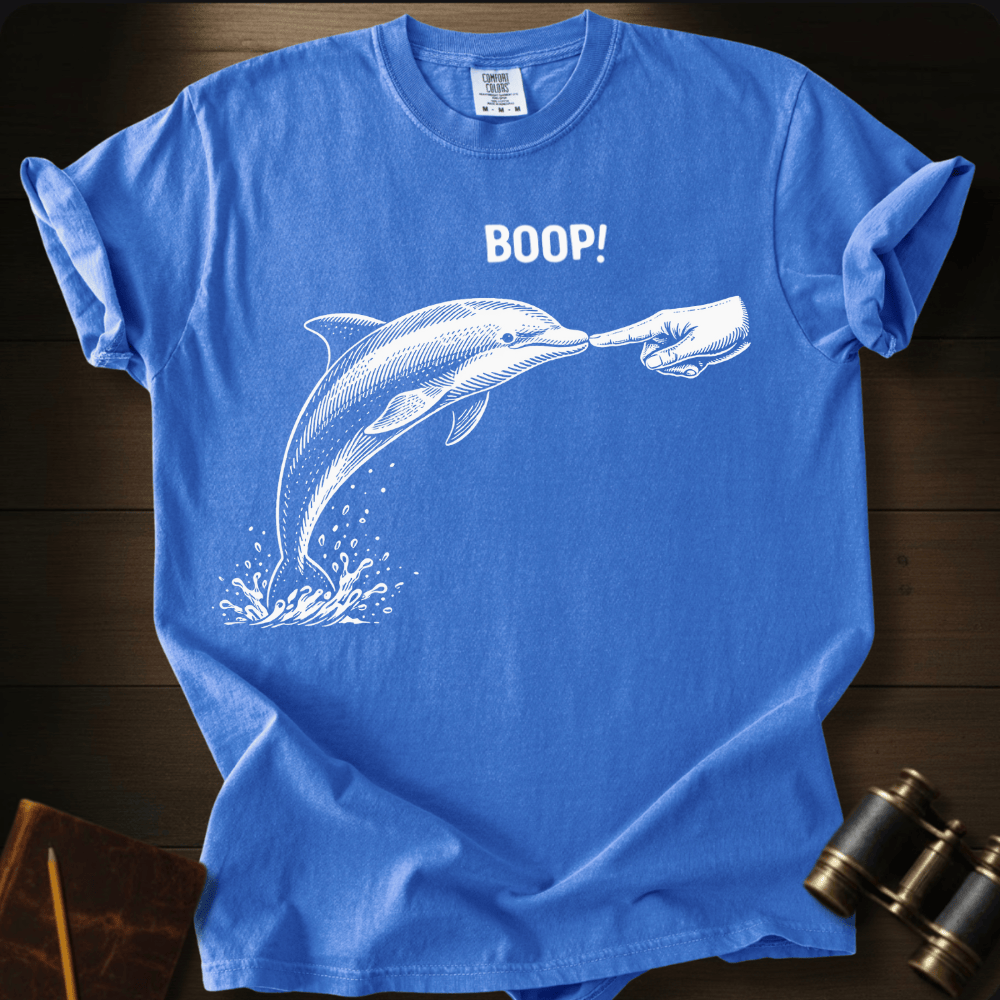 Full Sail Marine Boop! dolphin graphic Comfort Colors t-shirt in flo blue – white dolphin being booped on nose with hand and BOOP text design – front view