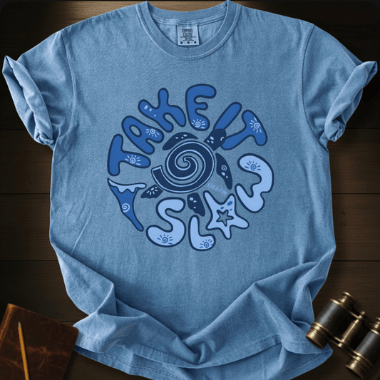 Full Sail Marine Take It Slow turtle swirl graphic Comfort Colors t-shirt in Blue Jean – navy turtle shell spiral with ocean elements starfish and waves TAKE IT SLOW text design – front view