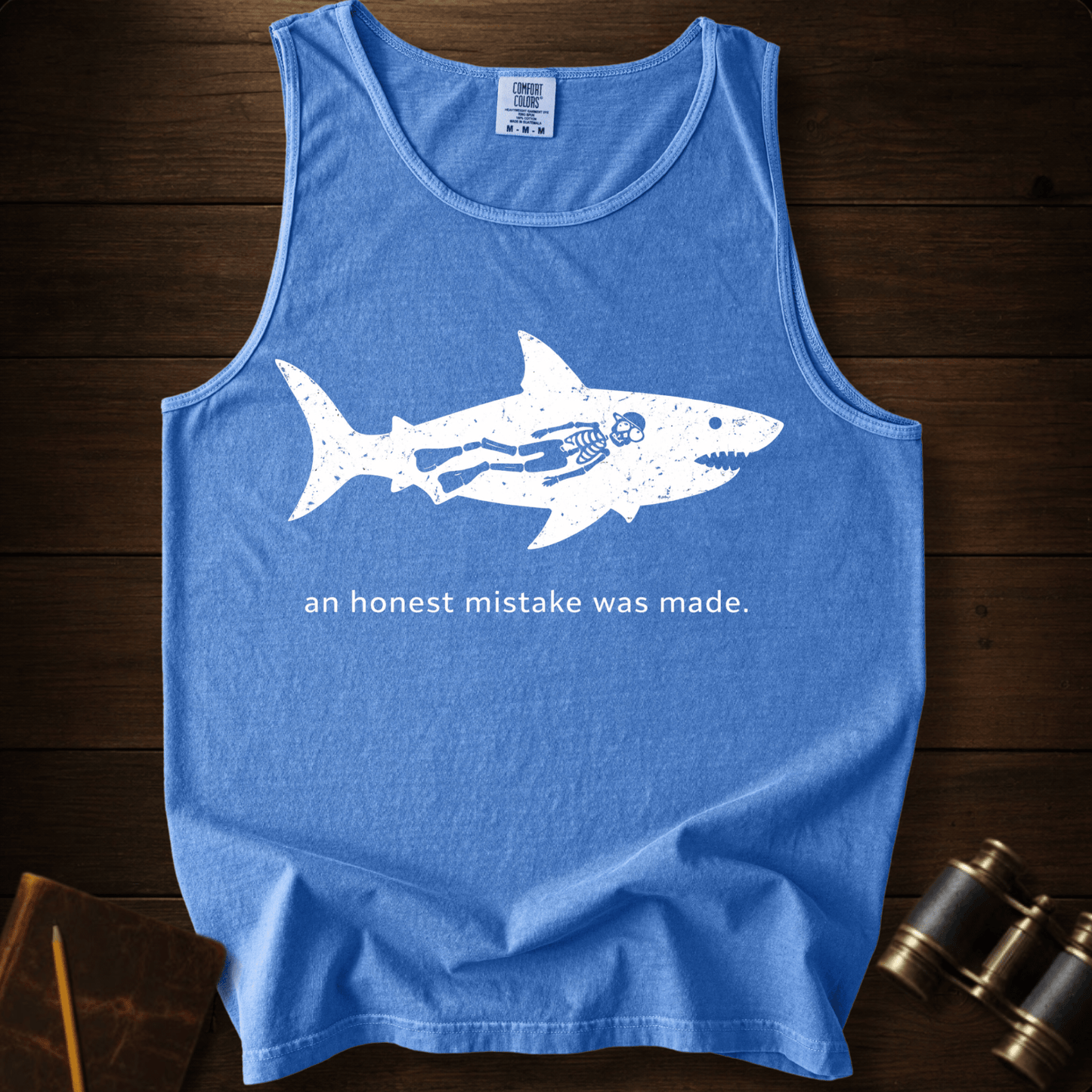 Full Sail Marine An Honest Mistake shark skeleton graphic Comfort Colors tank top in Flo Blue – funny ocean art quote design – front view
