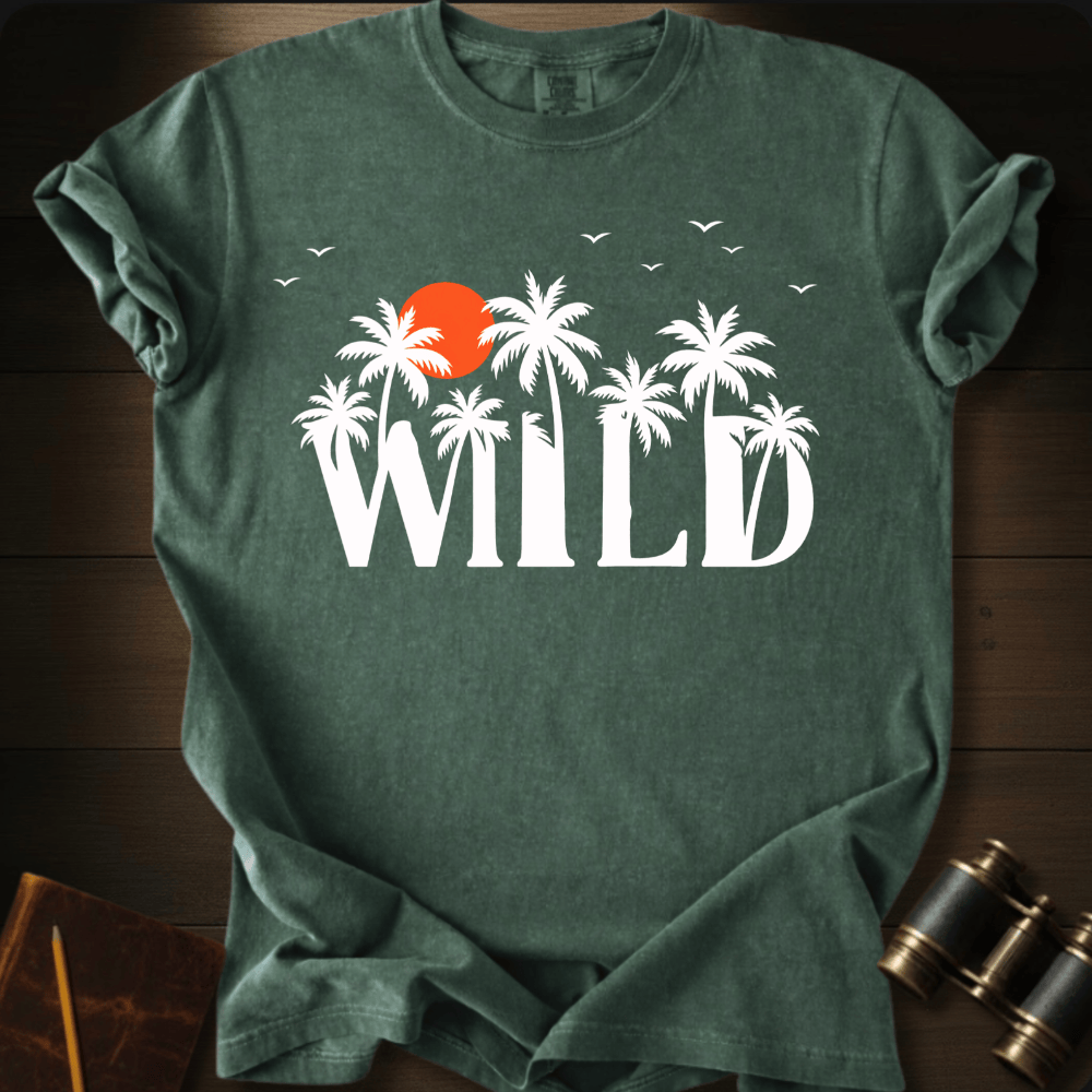 Full Sail Marine Wild palm trees and sunset graphic Comfort Colors t-shirt in hemp green – white tropical WILD text with orange sun and birds design – front view