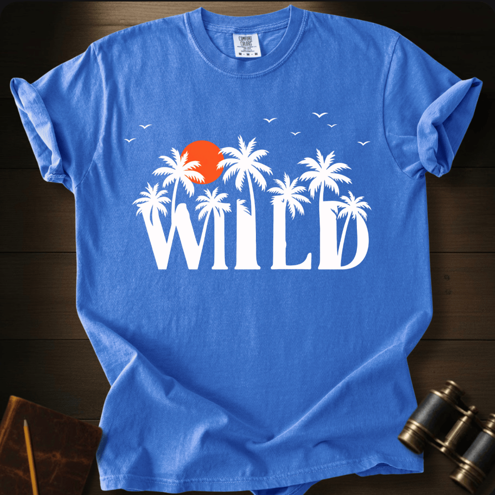 Full Sail Marine Wild palm trees and sunset graphic Comfort Colors t-shirt in flo blue – white tropical WILD text with orange sun and birds design – front view