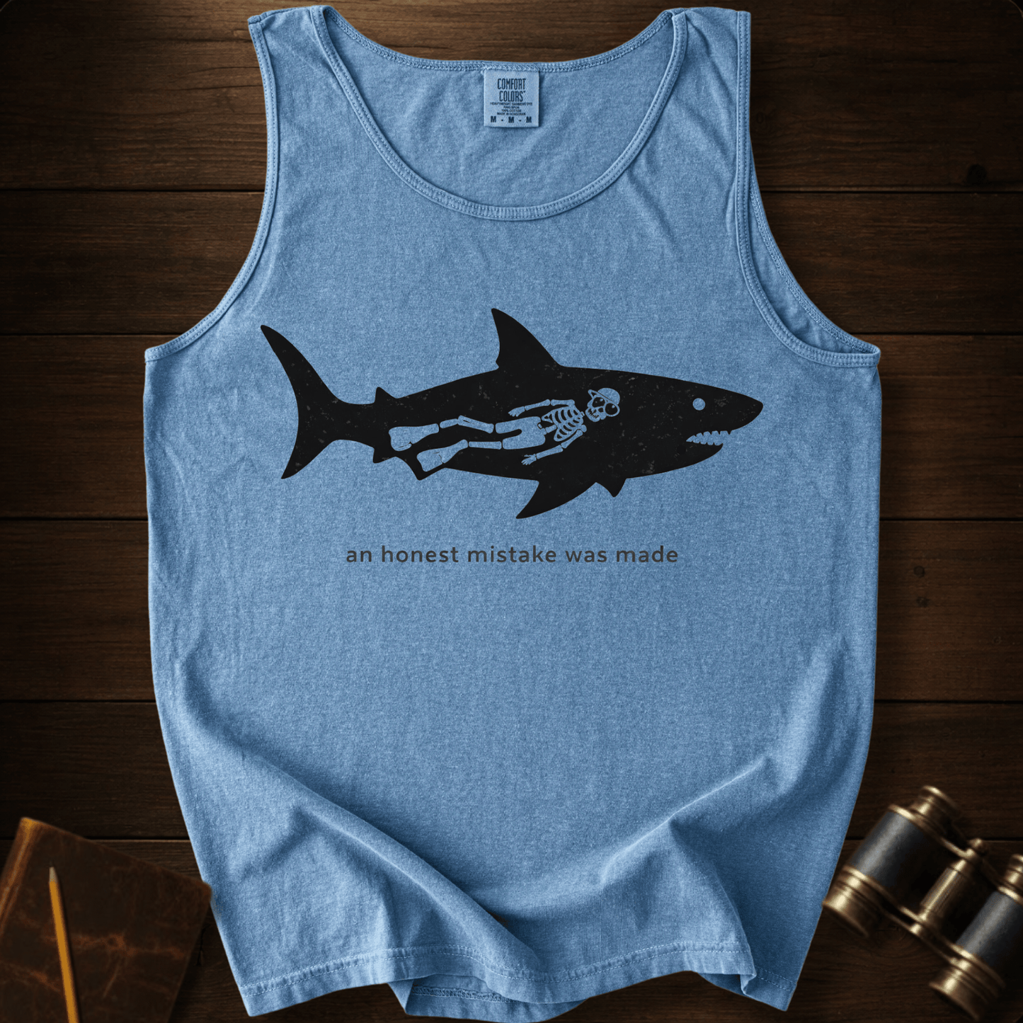 Full Sail Marine An Honest Mistake shark skeleton graphic Comfort Colors tank top in Blue Jean – funny ocean art quote design – front view