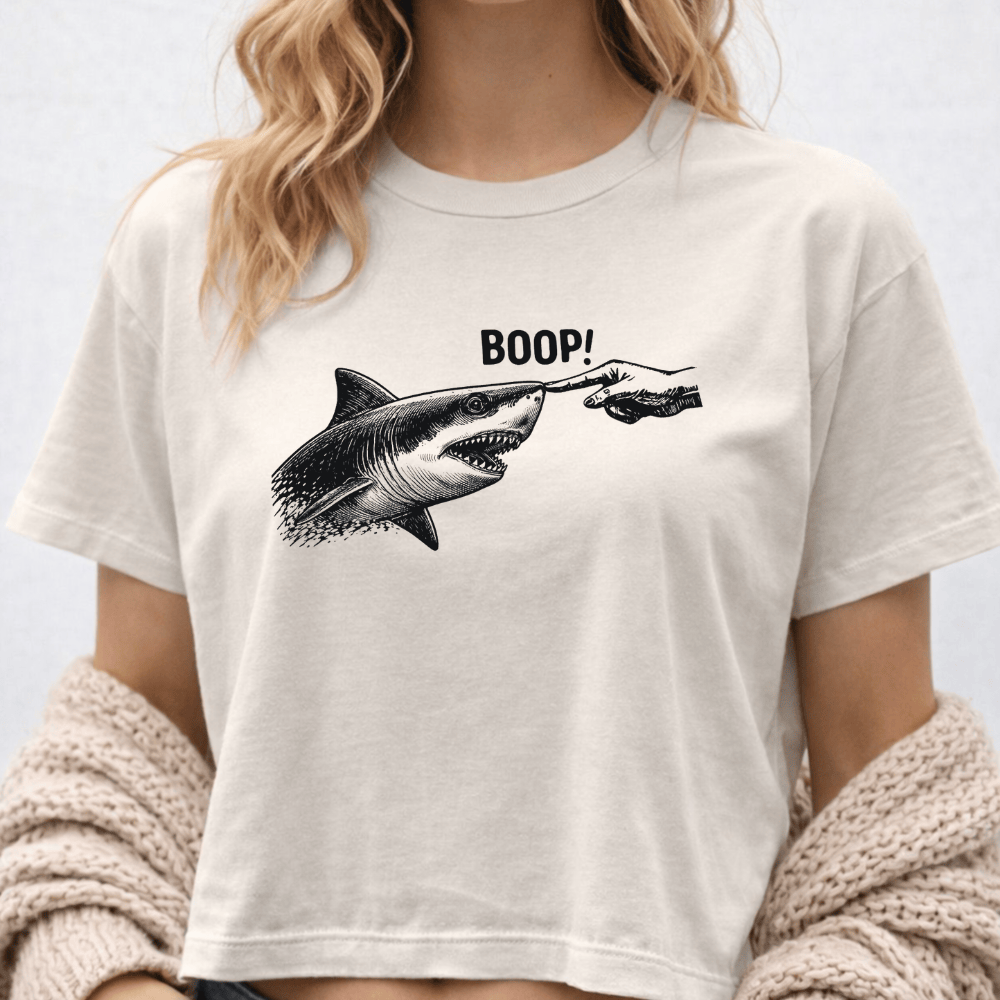 Full Sail Marine Boop shark graphic women's boxy tee in white – model wearing oversized Comfort Colors tee with great white shark booping finger design – lifestyle view