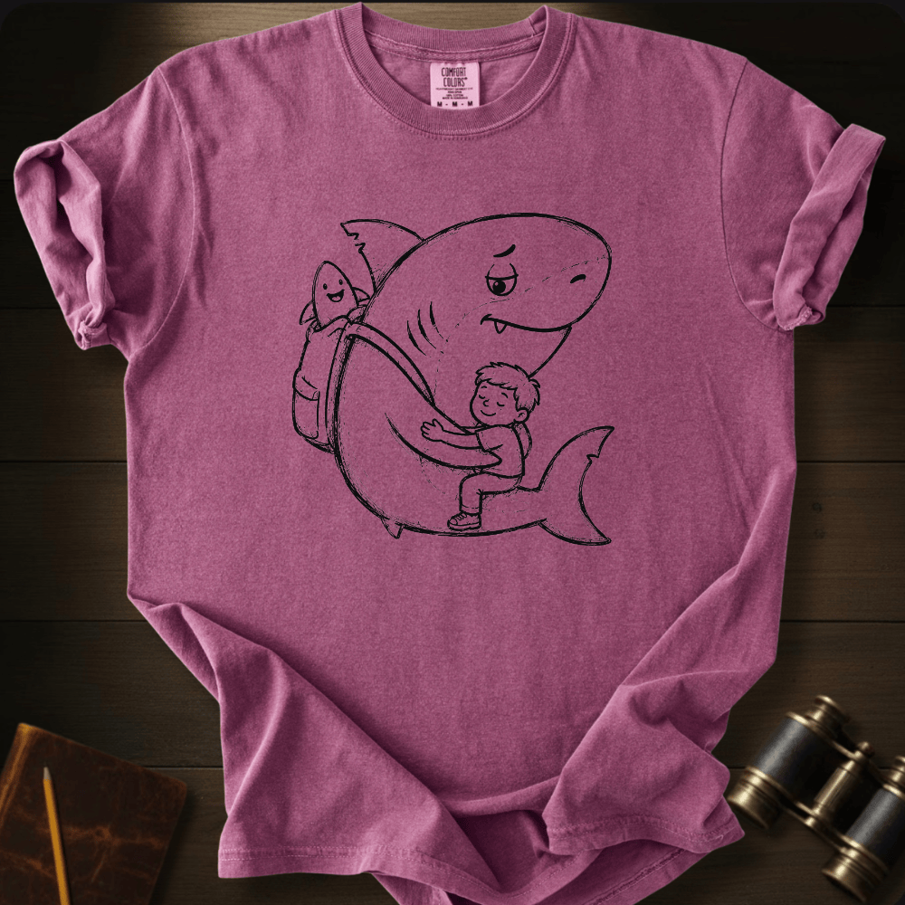 Cute hand-drawn shark and boy hug design with a baby shark in a backpack on a mustard yellow Comfort Colors tee.