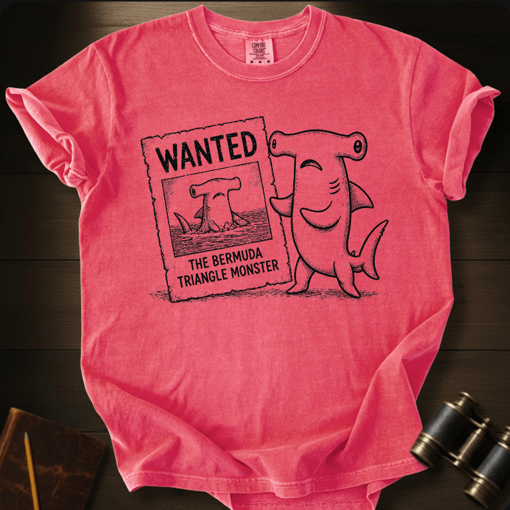 Watermelon hammerhead shark holding a 'Wanted: The Bermuda Triangle Monster' poster.