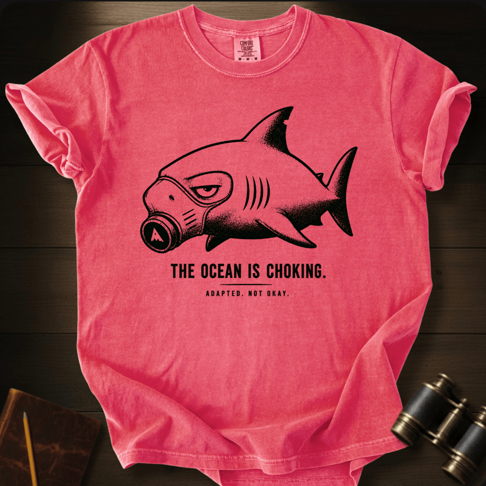 Masked shark graphic with "The Ocean Is Choking" on a watermelon Comfort Colors t-shirt