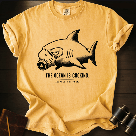 Gas-mask shark line art on a mustard Comfort Colors t-shirt, front flat lay